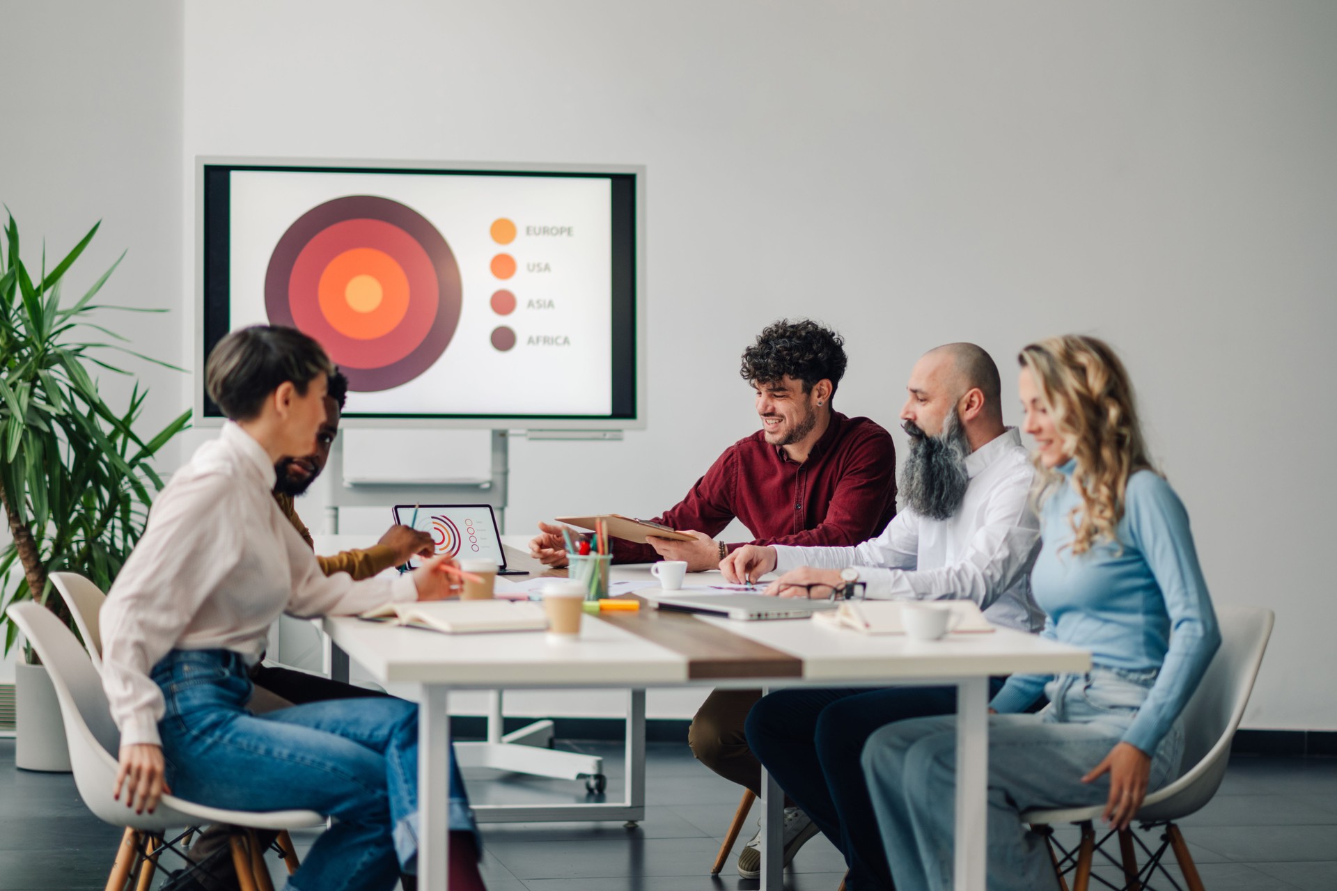 Business team analyzing global market data during office meeting