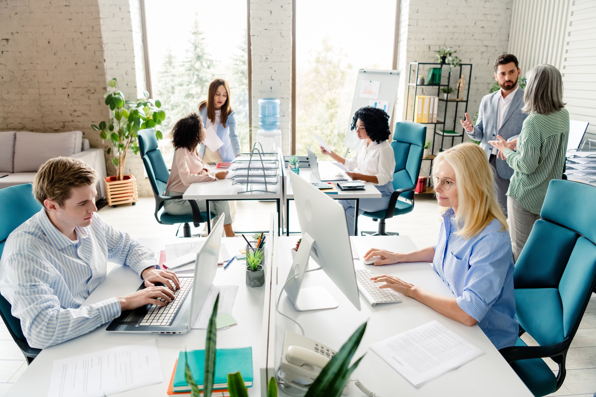 Modern workspace with teams collaborating in a professional and creative office setting, multi-age