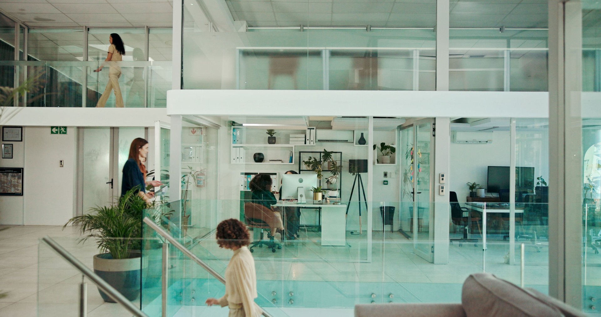 Modern building, walking and business people in office for coworking, productivity and synergy. Professional, corporate and workers in glass workplace for meeting, working and busy for career or job